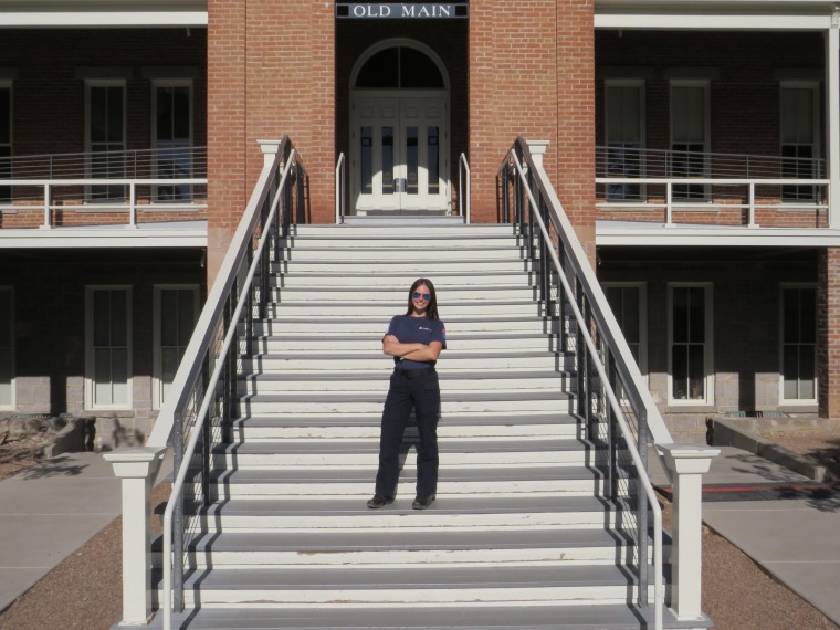 Halle Johnson standing on the Old Main stairs